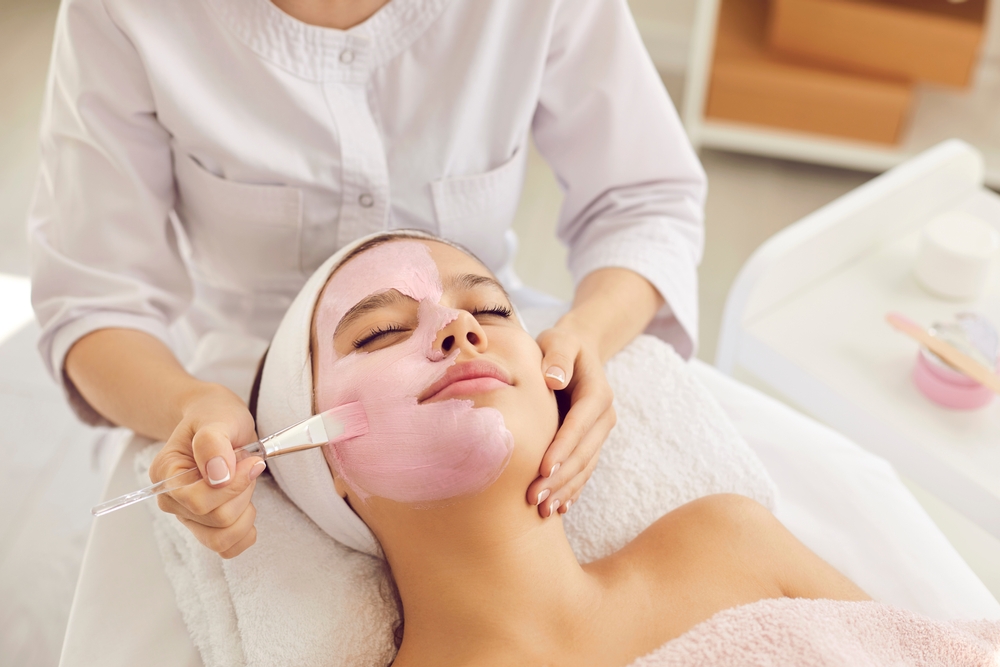 Skincare specialist providing a teen facial treatment at a medical spa in Huntington, NY.